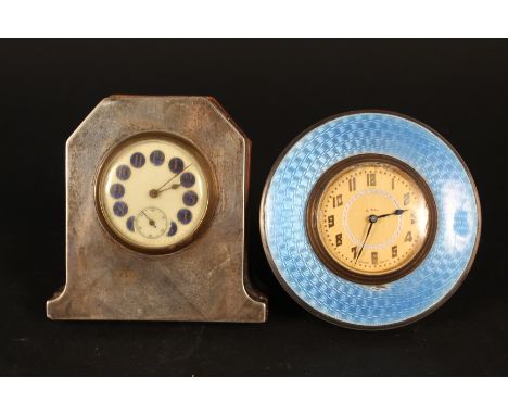 Two silver fronted bedside clocks, one with blue enamel decoration (one small loss of enamel)