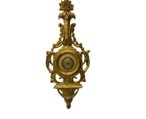A 20th century Italian barometer in a carved gilt wood case in the late 18th century rococo style, with an English aneroid mo