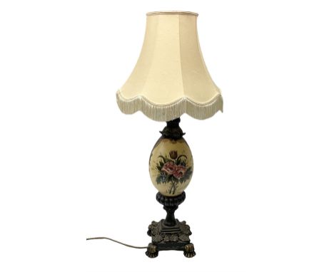 Late 19th/early 20th century table lamp, the ovoid  shaped body decorated ornately with painted floral sprays, raised upon fo