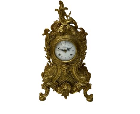A 20th century Italian striking mantle clock in a brass case in the late 18th century Rocco style, with an enamel dial with R