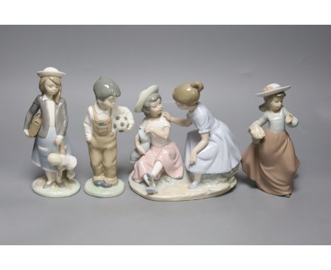   A Lladro figure, height 20cm, and three Nao figures