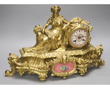   A late 19th century French gilt brass figural mantel clock, Sevres style plaques, length 47cm