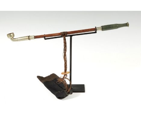 Pipe and tobacco pouch; Yunnan, China, 19th century.Jade, wood, agate and steel, with signature.On iron stand.Measurements: 4