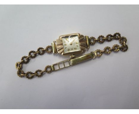 A 9ct yellow gold ladies manual Invicta wristwatch on a plated strap, total weight approx 12.3 grams, running 