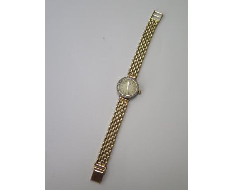 An 18ct yellow and white gold diamond set manual wind ladies wristwatch on a 9ct yellow gold bricklink bracelet, 20mm case, 1