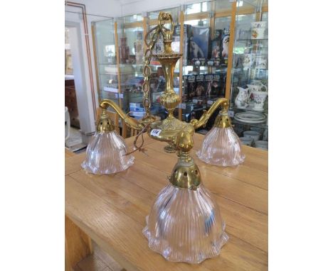 A brass three branch ceiling light with three Holophane shades 56 cm