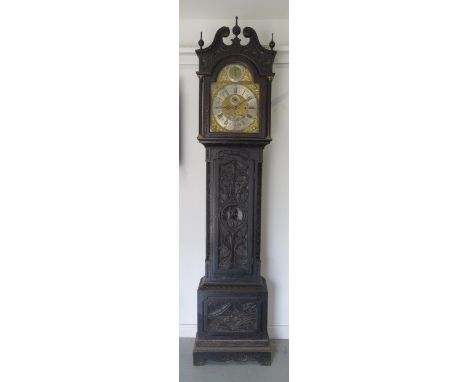 An impressive carved oak 8 day three train longcase clock, quarter chiming on eight bells and striking on a gong, the 15" arc