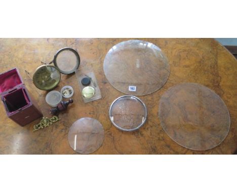 A 12 5/16" convex clock glass, an 11 3/4" clock glass, 2 x 5 3/4" convex glasses and assorted clock parts etc 
