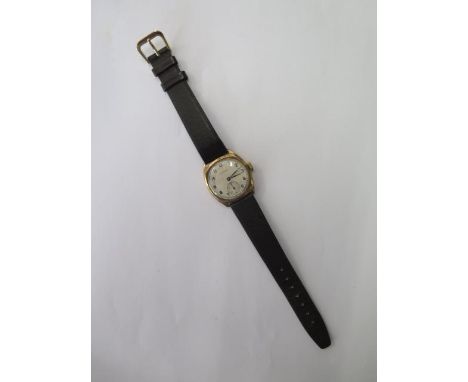 A manual wind gents 9ct gold presentation Leonex watch on leather strap, running, hands adjust, total weight approx 22 grams 