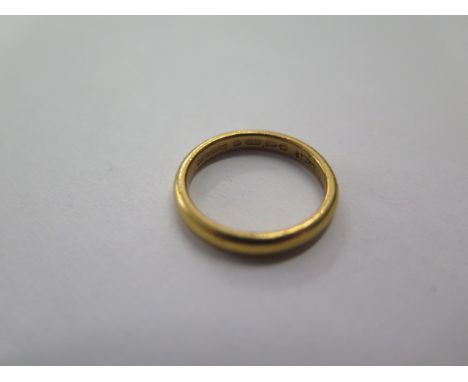 A hallmarked 22ct yellow gold band ring, size K, approx 4.2 grams, some general usage marks 