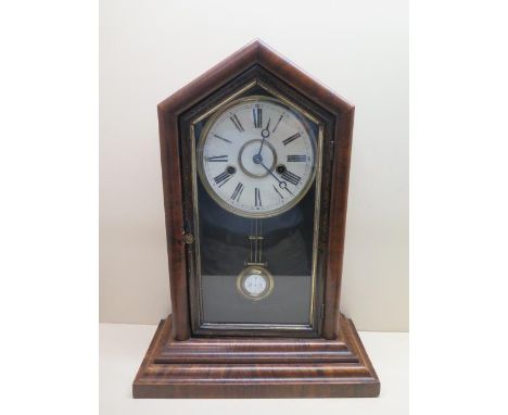 An American walnut mantle clock striking on a gong, 46cm tall, ticks but stops 