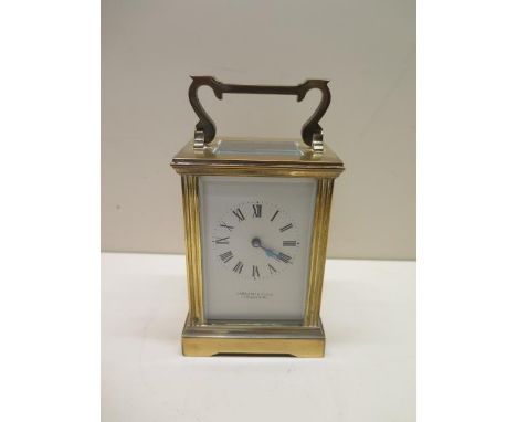 A brass French carriage clock, the dial signed Garrard &amp; Co Ltd, 15cm tall with handle up, with key, running, glass good 