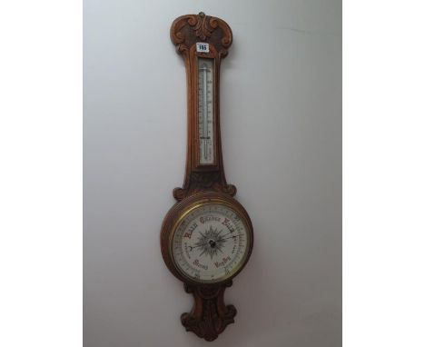 A carved oak aneroid / barometer with thermometer, 86cm tall 