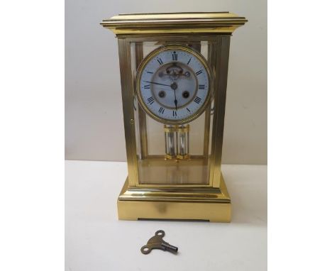 A good four glass gilt brass mantle clock with exposed escapement and mercury pendulum, striking on a gong, 33cm tall x 19cm 