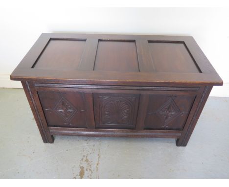 An early 20th century oak 3 panel coffer with carved front, in polished condition, 76cm tall x 91cm x 47cm 