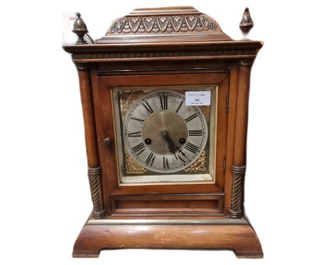 Early 20th century German two train walnut cased architectural mantle clock with brass face having silvered Roman chapter rin