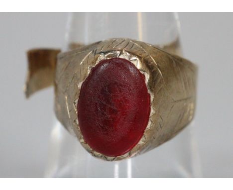 Yellow metal ring with a red stone (cut), 3.5g approx.  (B.P. 21% + VAT) 