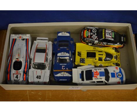 Six model Porsche racing cars.