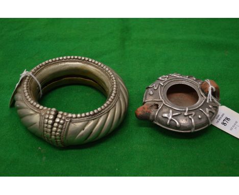 A silver mounted terracotta oil lamp and a large white metal bangle.