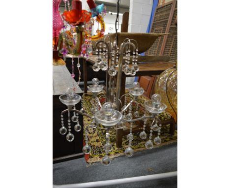 A stylish chrome and glass five branch chandelier.