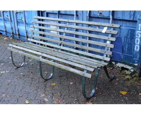 A wrought iron and wooden slatted garden bench.