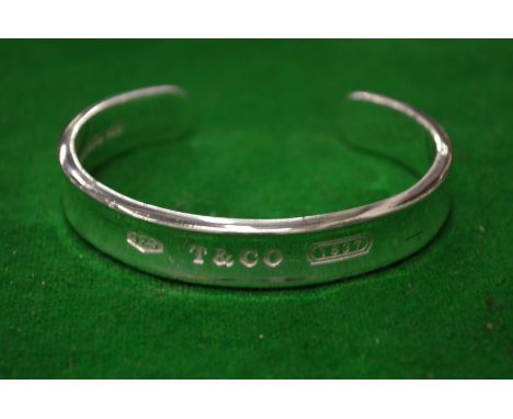 Tiffany &amp; Co, a silver bangle, boxed.