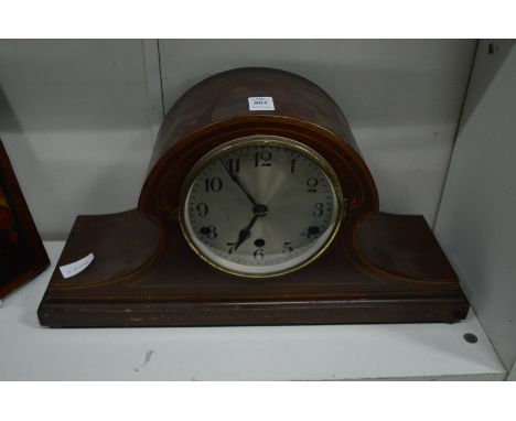 A mahogany mantel clock.