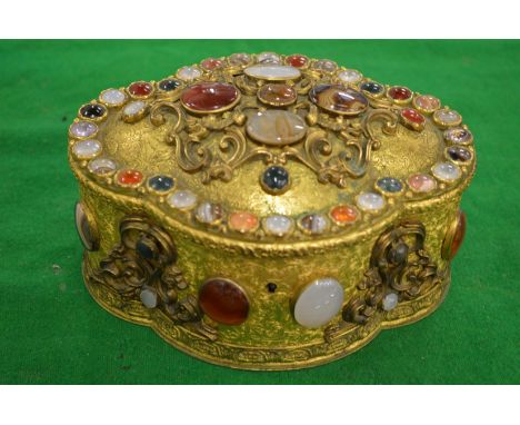 A good Continental gilt metal jewellery casket set with numerous agate, jade and other stones.