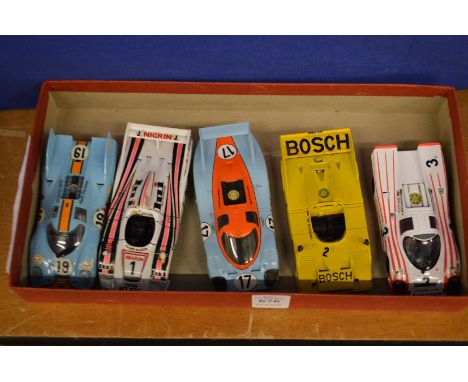 Five model Porsche racing cars.