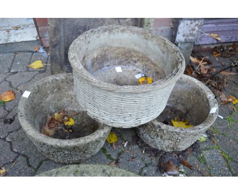 A pair of composite garden planters and a similar basket weave style planter.