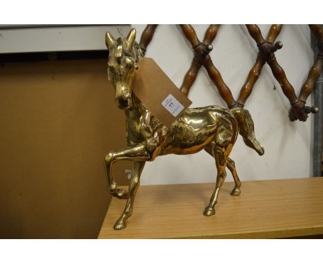 A large brass model of a horse.