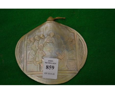A carved mother of pearl shell.