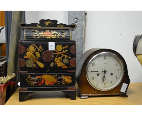 Japanese lacquer table top cabinet and a mantel clock.