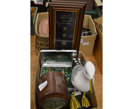 Carved and painted wood seagull, a mantel clock, tin of marbles and presentation coins frame and glazed.