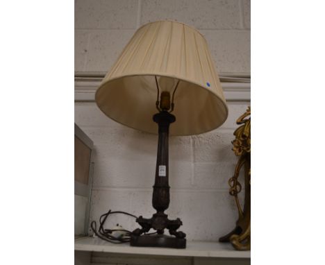 An ornate brass table lamp.