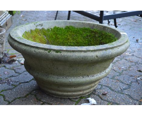 A large circular composite garden planter.