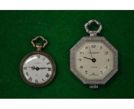 A miniature silver fob watch and another fob watch.