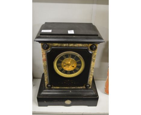 A large slate mantel clock.