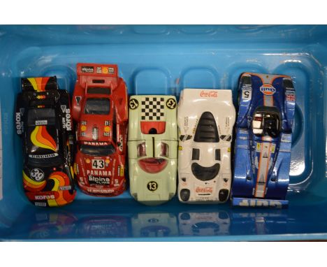 Five model Porsche racing cars.