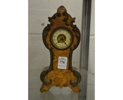 A miniature mantel clock.