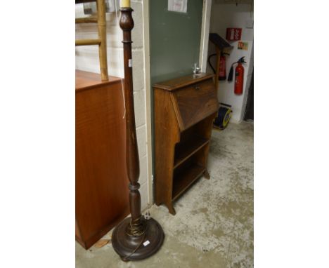 A standard lamp and oak bureau.