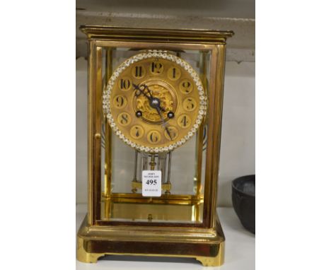 A good brass cased four glass mantel clock with mercury pendulum.