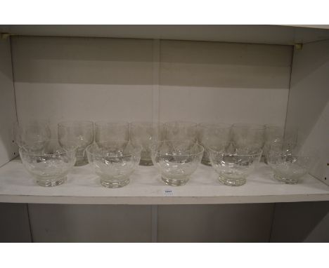 A shelf of engraved glassware.