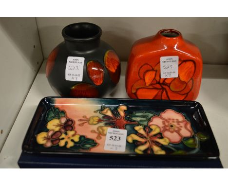 A Moorcroft rectangular pin tray with original box and two Poole pottery vases.