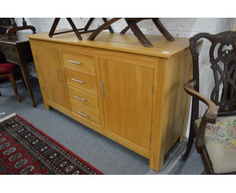 A modern light oak sideboard.