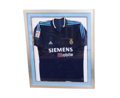 Real Madrid: A framed and glazed, signed Real Madrid 2003-04 away football shirt, signed by sixteen players. Frame measuring 