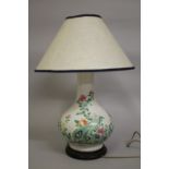 A 19TH CENTURY CHINESE FAMILLE VERTE PORCELAIN VASE CONVERTED TO A LAMP, painted with flora upon a