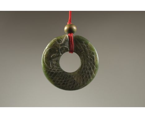 A CHINESE CARVED JADE LUCKY RING.
