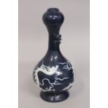 A CHINESE SACRIFICIAL BLUE GARLIC HEAD DRAGON VASE, with carved white dragon to the body, the neck