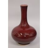 A LARGE CHINESE IRON RED PORCELAIN VASE, the base with character mark, 34cm high.
